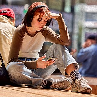 Visitor taking a break in front of the Art Basel entrance – a contemplative moment documented by the Bluesun photography team.