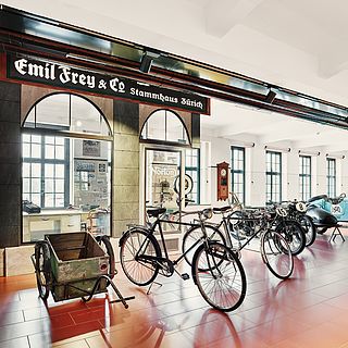 Exhibition photography by Bluesun: historic bicycles, workshop scenes and vintage vehicles at the Emil Frey Museum in Safenwil – atmospheric lighting and authentic details.