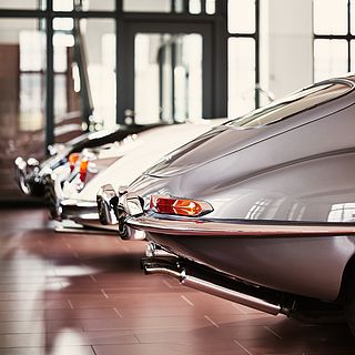 Close-up of the elegant rear of a Jaguar E-Type at the Emil Frey Classic Center – photographed by Bluesun with a focus on form, chrome, and lighting atmosphere.