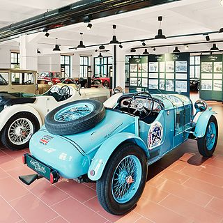 Vintage car exhibition at the Emil Frey Museum with historic vehicles and information boards - professionally photographed by Bluesun for an authentic atmosphere and richness of detail.