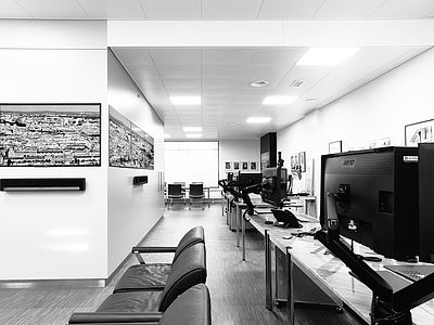 View of the Bluesun Web Studio in Basel with large monitors, creative workstations and fine art photography. Professional space for web design, photo editing and high-end print production.