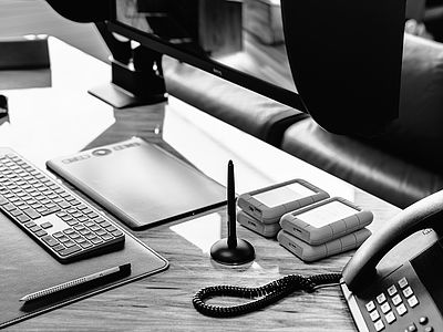 Workstation with keyboard, Wacom Intuos Pro tablet, Lacie hard drives and professional BenQ monitor at Bluesun Creative Studio Basel – digital workflow for web design, development and fine art printing.